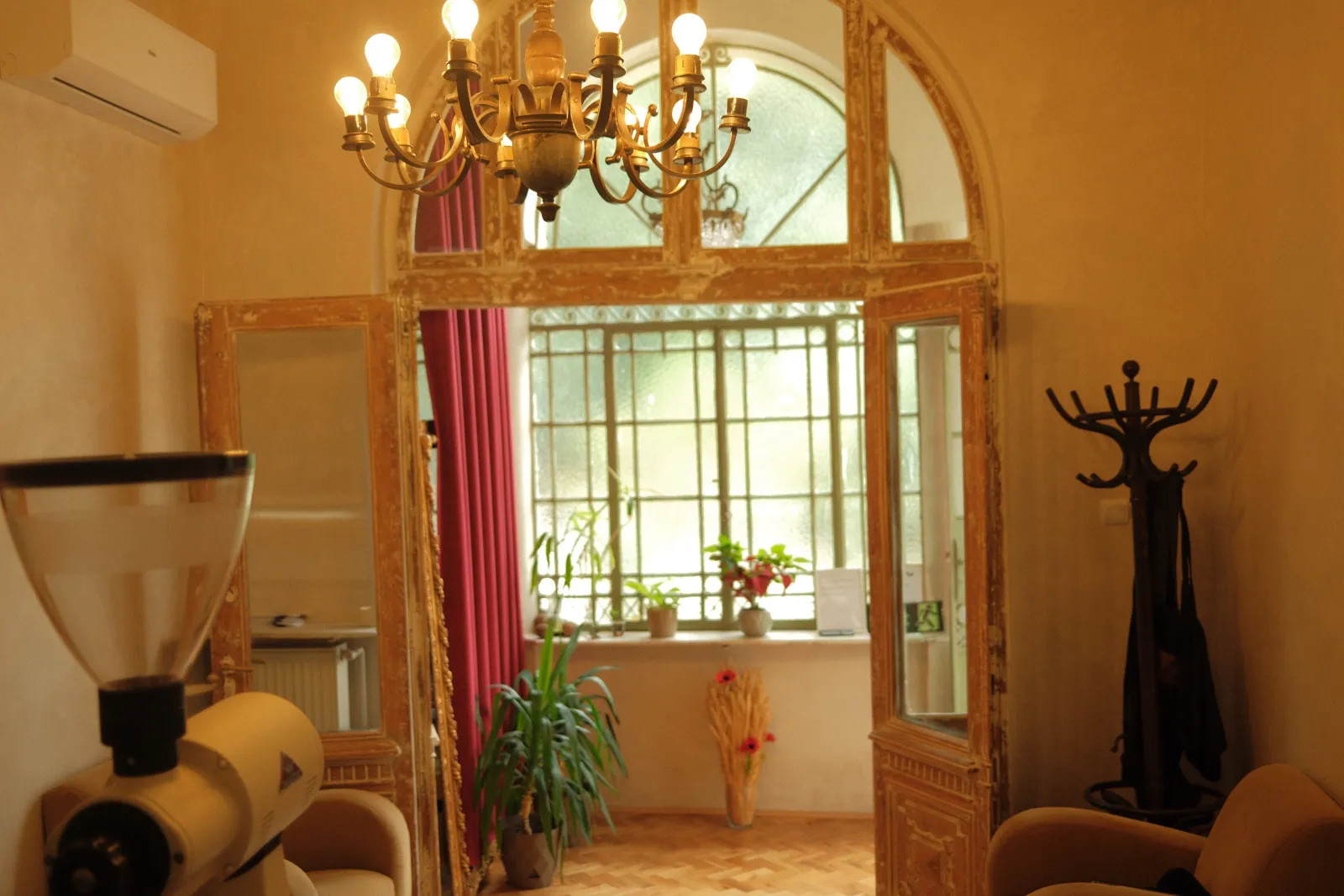 A chandelier over the arched doorway between two rooms of the villa